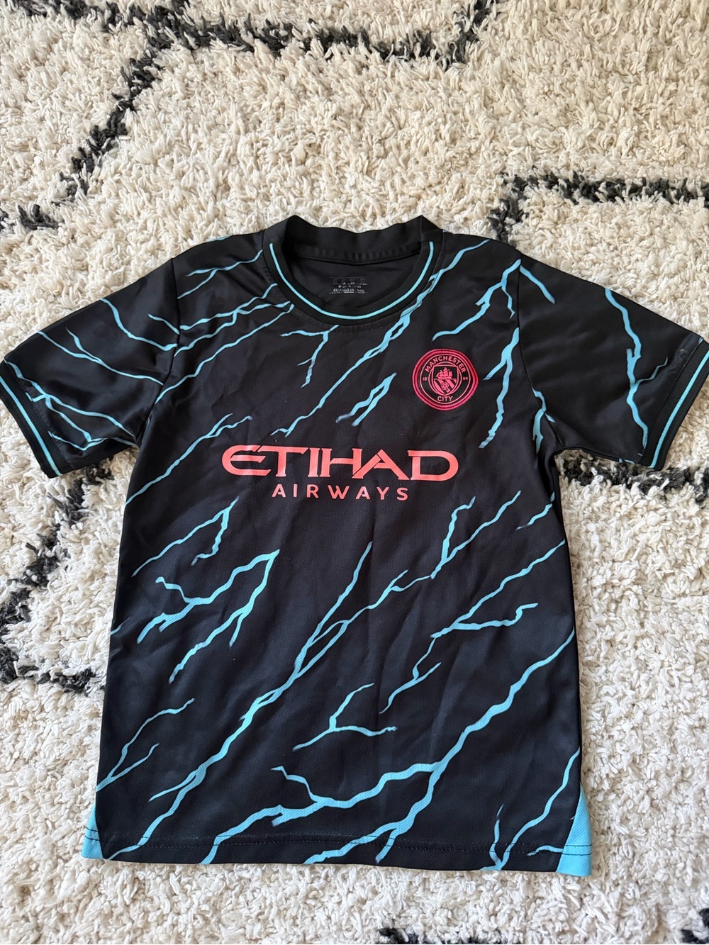 Puma Kids Black Tee with Teal Lightning and Coral Logo